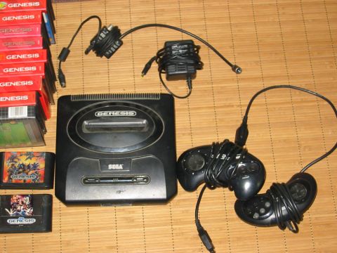 1996 Ford Bronco - Sega Genesis console bundle with games and controllers, laid out on a wooden surface.