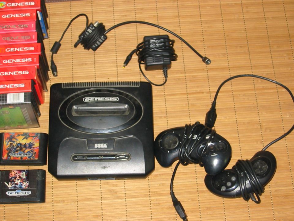 Sega Genesis console, two controllers, games, and power adapters