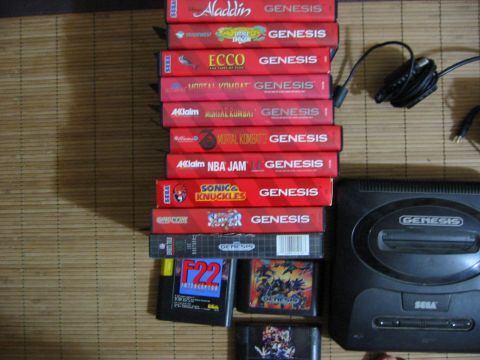 1996 Ford Bronco - A collection of Sega Genesis game cartridges, including titles like Aladdin and Mortal Kombat, are displayed alongside the console and its…