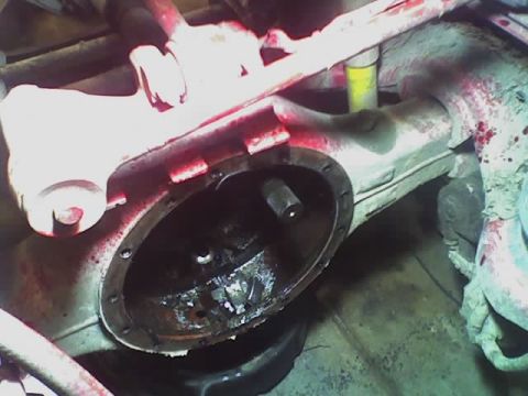 1992 Ford Bronco - Close-up view of a vehicle's differential housing, showing internal components and red fluid.
