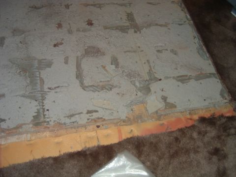 1992 Ford Probe - Close-up of worn car interior floor carpet showing padding and debris underneath.