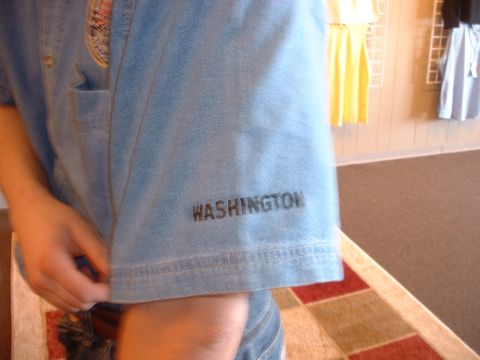 2000 Ford Crown Victoria - A close-up view of a blue denim shirt sleeve shows the word WASHINGTON printed in black text.