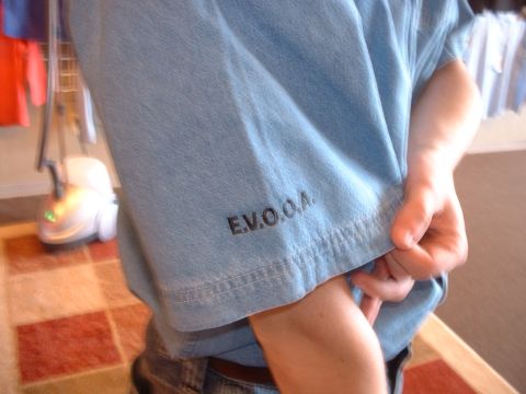 2000 Ford Crown Victoria - Close-up of a light blue t-shirt with the embroidered text E.V.O.O.A.