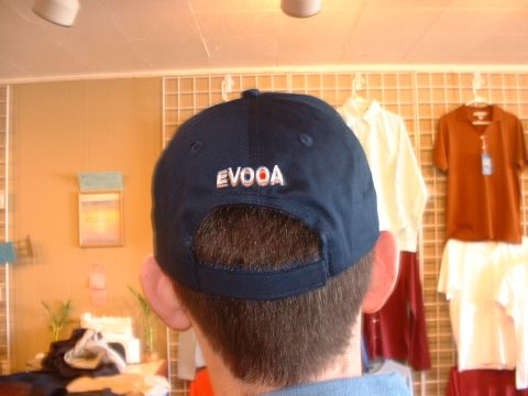 2000 Ford Crown Victoria - A person wears a navy blue baseball cap with the text 'EVOOA' on the back.