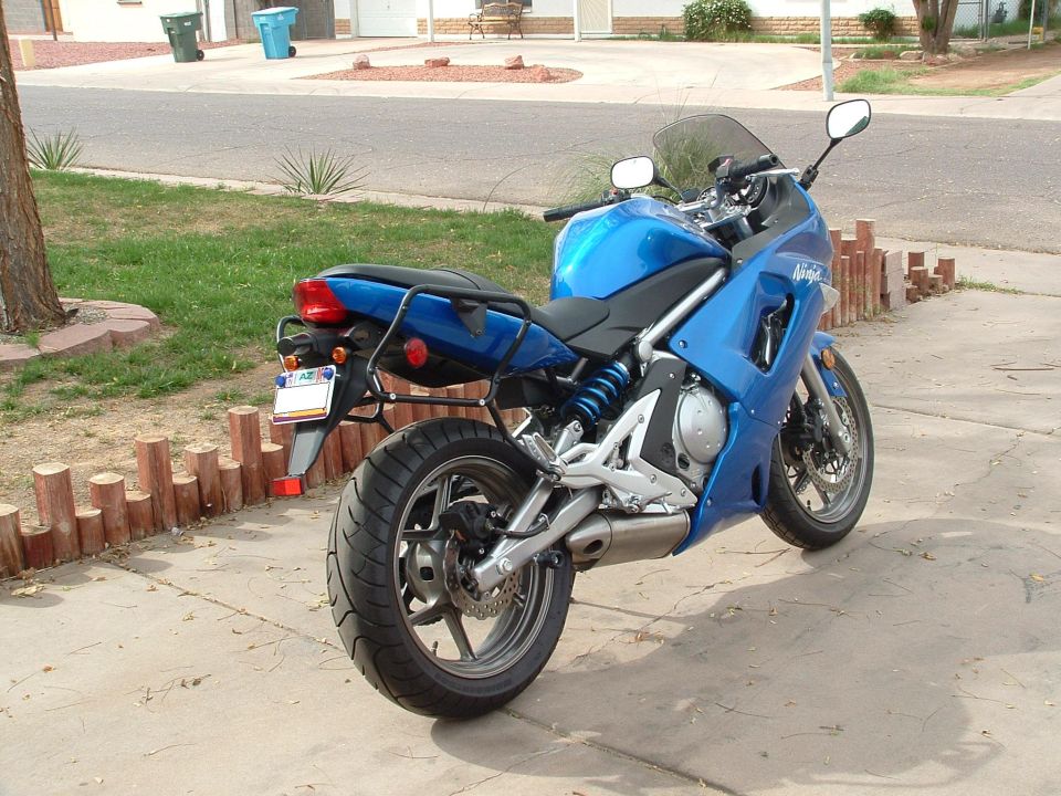 Blue Kawasaki Ninja from rear three-quarter with black luggage rack fitted
