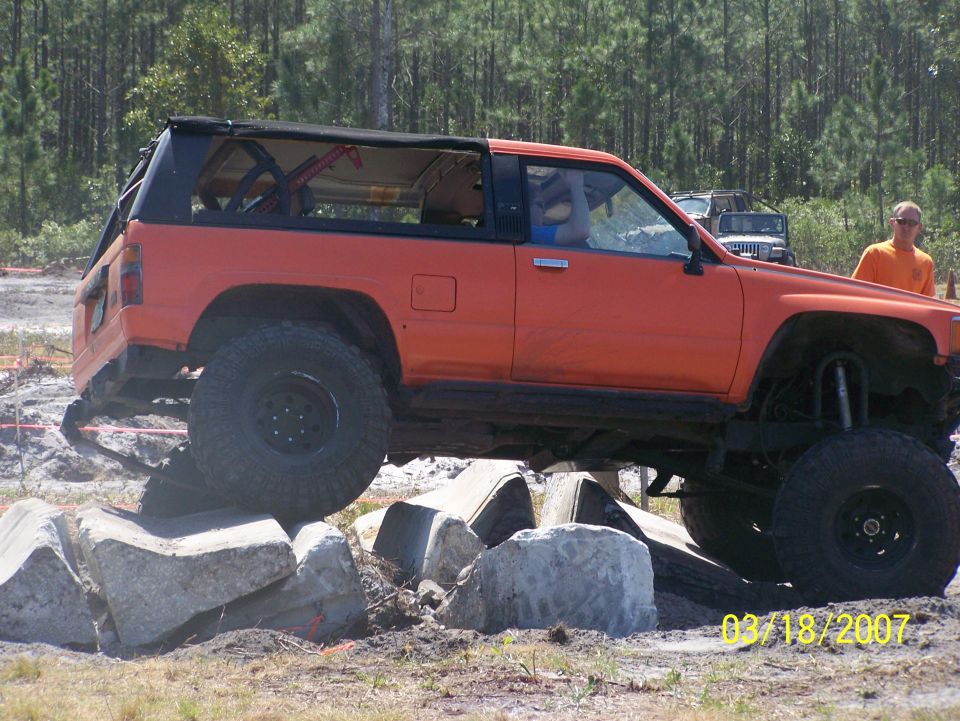 Orange SUV with lifted suspension on rocks. Date 03/18/2007