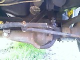 1986 Ford Bronco - Close-up view of the vehicle's undercarriage, showing suspension components and a differential.