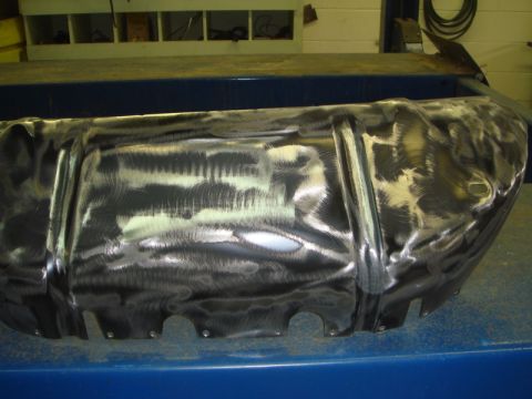 1996 Ford Bronco - This metal part has been ground and shows circular cutouts along its lower edge.