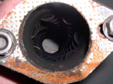 1996 Ford Probe - Rusty exhaust pipe flange with internal baffles visible inside the opening.