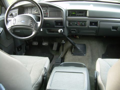 1992 Ford Bronco - The interior of a 1992 Ford Bronco shows a manual transmission and grey cloth seats.