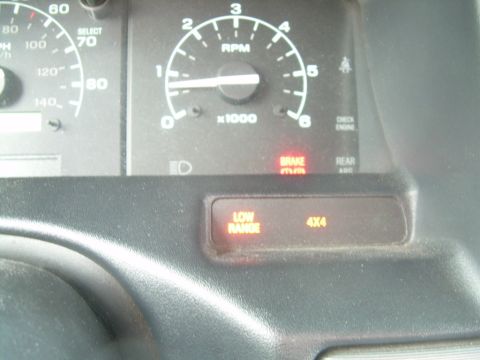 1992 Ford Bronco - Dashboard gauges and illuminated 'LOW RANGE' and '4X4' indicators are visible in this interior view.