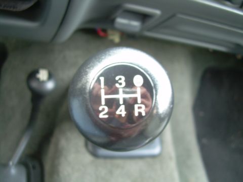 1992 Ford Bronco - Close-up of a manual transmission gear shifter, showing the gear pattern and a second shifter.