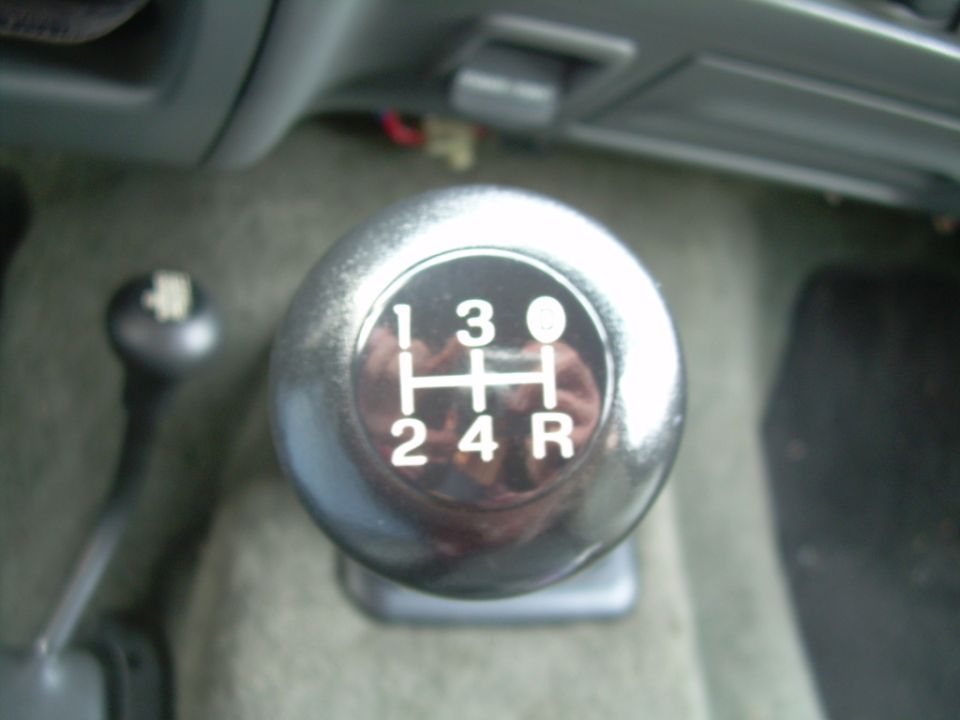 Black five-speed manual shift knob with 5-speed gate pattern and transfer case lever