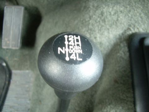 1992 Ford Bronco - The vehicle's four-wheel drive shifter is visible, showing the different gear selections available.