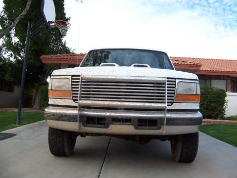 1996 Ford Bronco - Frontal view of a white Ford F-Series truck, showing its grille and headlights. The model year appears to be between 1992 and 1997.