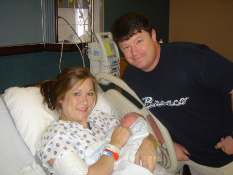 1995 Ford Bronco - A family celebrates the arrival of their new baby in a hospital room, with medical equipment in the background.