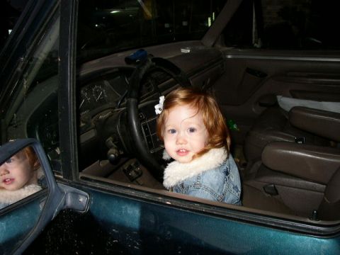 1995 Ford Bronco - Children are visible inside the interior of a dark green SUV.