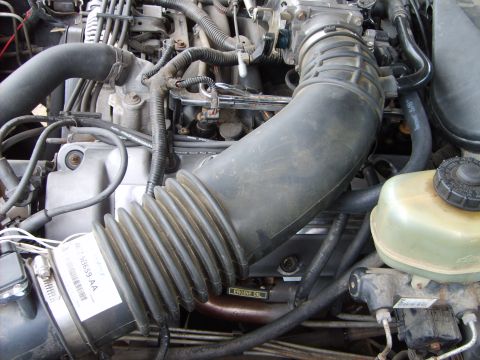 1993 Ford Crown Victoria - Close-up view of an engine bay, showing various components and a label indicating 'ENGINE OIL'.