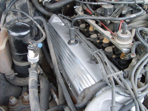 1993 Ford Crown Victoria - Close-up view of an engine bay, showing a chrome valve cover and fuel injectors.
