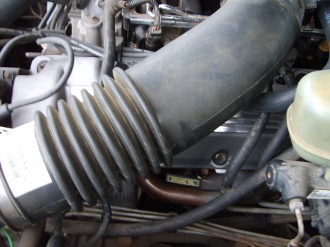 1993 Ford Crown Victoria - Engine bay detail with air intake hose and visible 'ENGINE OIL' label.