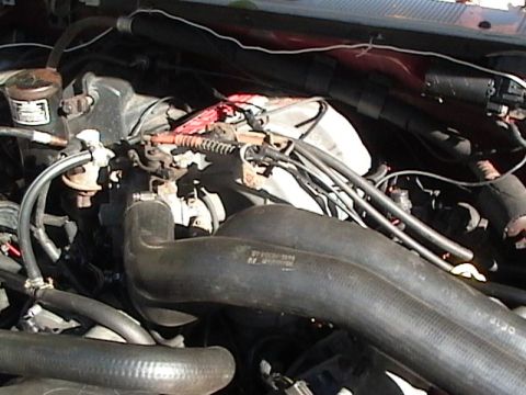 1990 Ford Bronco - Close-up view of the engine compartment, showing various components and wiring.