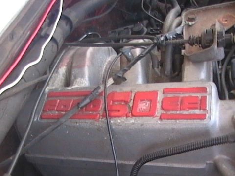 1990 Ford Bronco - Close-up of an engine intake manifold with visible "5.0 EFI" lettering.