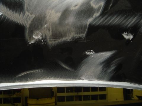 1996 Ford Bronco - Close-up view of a damaged inner fender with visible scratches and impact marks.