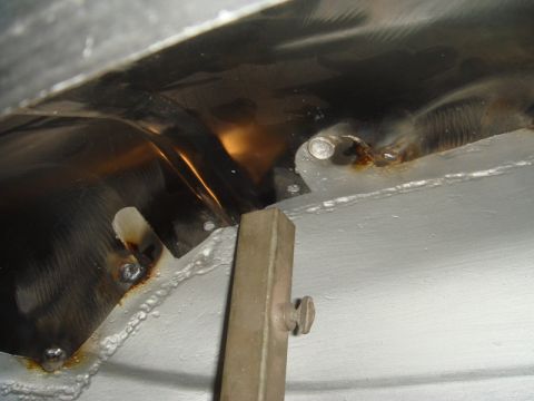 1996 Ford Bronco - Detail of a metal component, showing welds and signs of surface rust.