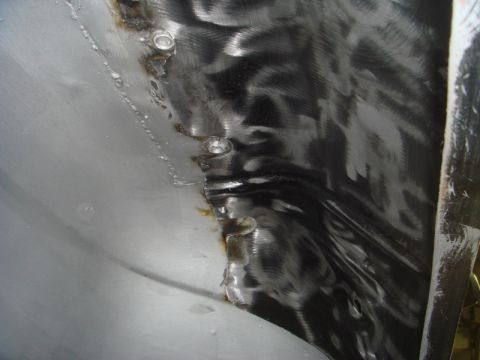 1996 Ford Bronco - Close-up view of metalwork on an inner fender, showing signs of repair and fabrication.