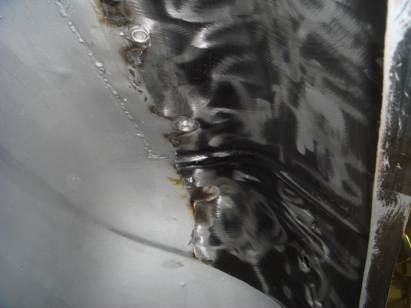 Inner fender metal with visible welds and grinding marks