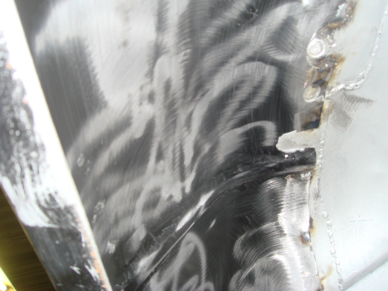 Inner fender with brushed metal finish and visible welds