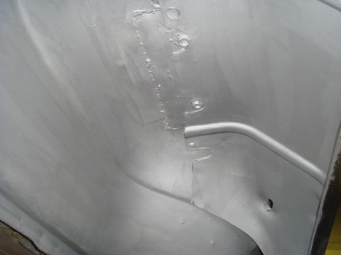 1996 Ford Bronco - Close-up view of a vehicle's inner fender panel, showing construction details.