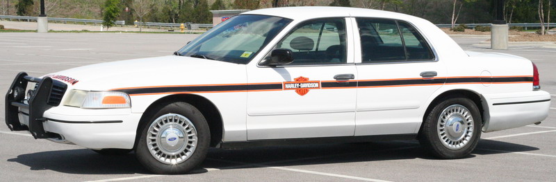 White 1999 Ford Crown Victoria with Harley-Davidson decals on the side