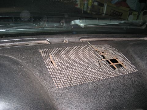 1970 Ford Mustang - The speaker grille on this car's dashboard is damaged, revealing the underlying structure.