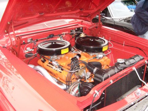 1990 Ford Bronco - Close-up of a V8 engine bay dual carburetors and a "426" designation badge.