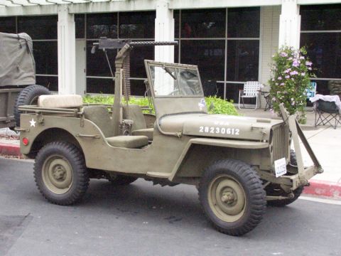 1990 Ford Bronco - This military jeep is equipped with a machine gun mount and appears to be from an older era.