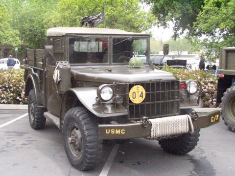1990 Ford Bronco - This olive drab military truck, marked USMC on the bumper, features a mounted machine gun and a helmet on the hood.
