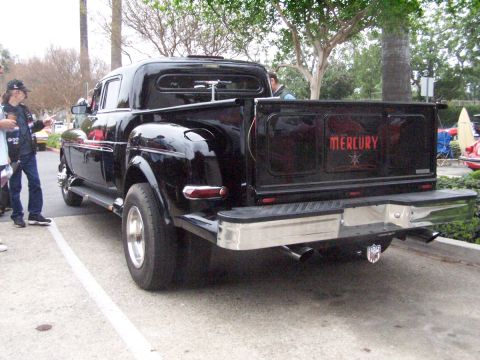 1990 Ford Bronco - A custom black pickup truck is shown from the rear, "MERCURY" lettering on its tailgate.