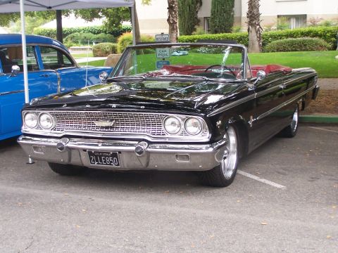 1990 Ford Bronco - Front view of a black 1963 Ford Galaxie convertible at a car show.