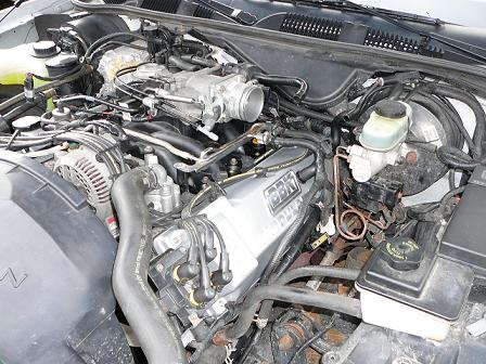 1997 Mercury Grand Marquis - Close-up view of a V8 engine bay, showing various components and wiring.