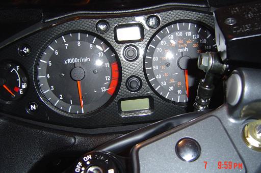 Motorcycle gauge cluster with tachometer and mph speedometer, dark faces and orange needles