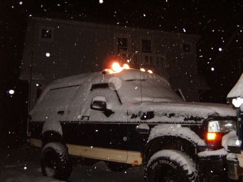 1993 Ford Bronco - A 1993 Ford Bronco sits covered in snow during a winter night, with a house in the background.