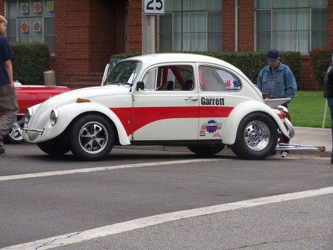 1990 Ford Bronco - Modified Volkswagen Beetle drag car with racing decals and a roll cage is parked on the street.
