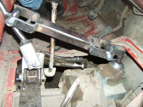 1980 Ford F-250 - Close-up of a manual transmission linkage, custom fabricated components and a pair of vise grips. The interior of the vehicle is visible.