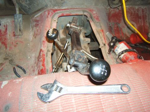 1980 Ford F-250 - Manual transmission shifters and tools are visible inside a vehicle's cabin.