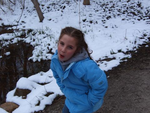 1993 Ford Bronco - A young girl in a blue winter jacket stands with her hands in her pockets in a snowy outdoor setting.