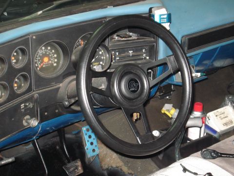 1979 Chevrolet C/K Pickup - The interior of a truck shows the dashboard with gauges, steering wheel, and radio controls.