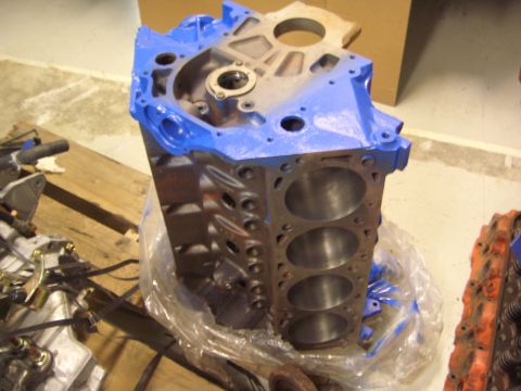 1996 Ford Bronco - A disassembled engine block is shown, with some parts painted blue and others showing rust.