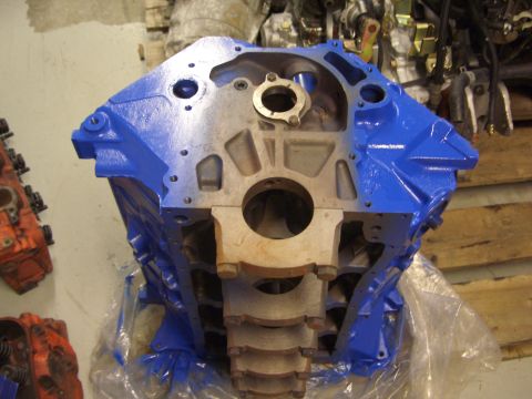 1996 Ford Bronco - A blue painted engine block is shown in a workshop setting, with other engine parts visible.