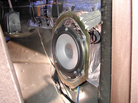 1996 Ford Bronco - Aftermarket speaker installation in a vehicle's interior, showing sound deadening material applied to the door panel.
